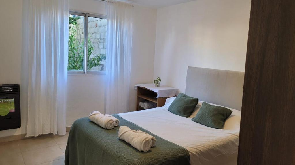 a bedroom with a bed with two pillows on it at Depto Diucon Centro in Esquel