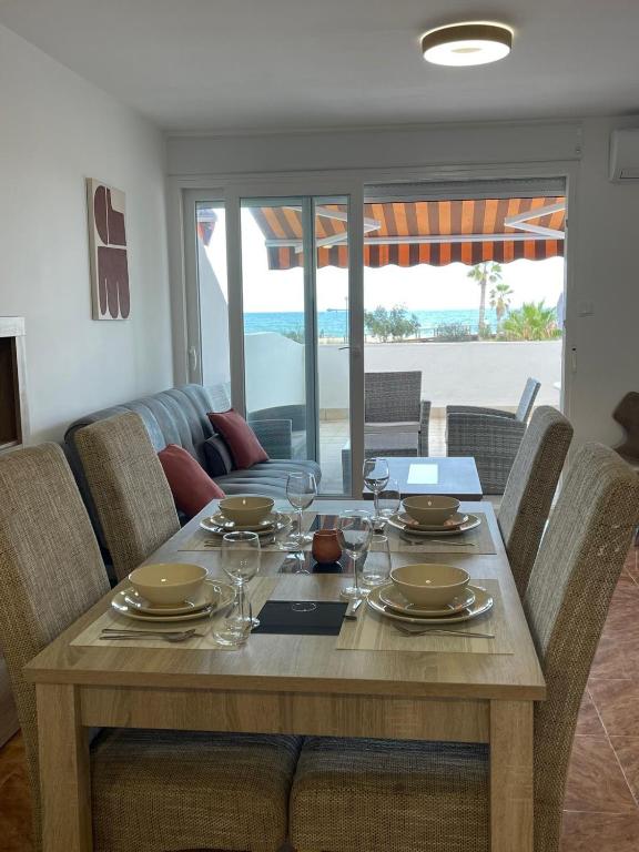 a wooden table with glasses and plates on it at Penismar Azul in Peniscola
