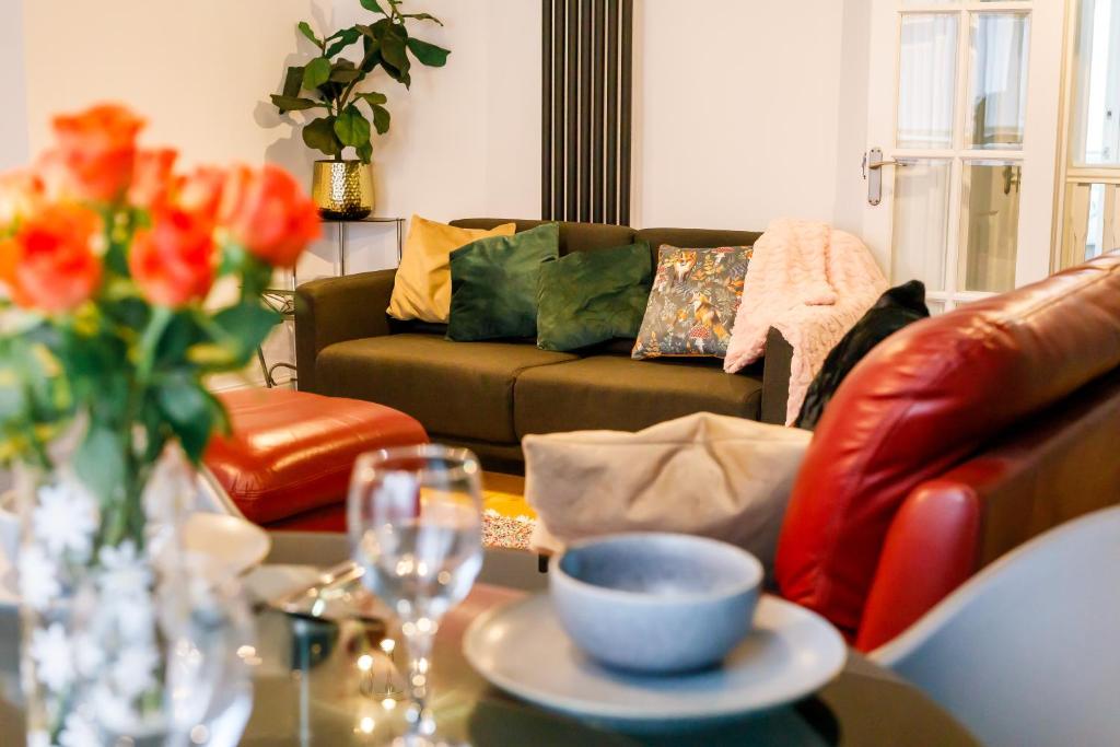 a living room with a couch and a table with a bowl at Spacious, Modern and stylish three bedroom home , perfect for work , leisure and contractors ,5 mins walk to Newcastle city Center, Newcastle stadium and Newcastle University, Free parking Fast WiFi, conveniently located both short stay and long stays in Newcastle upon Tyne