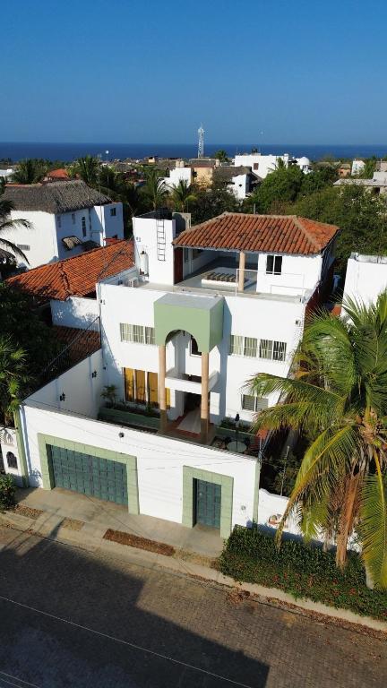 an aerial view of a white house with a palm tree at Casa Vemisa Puerto Escondido in Puerto Escondido