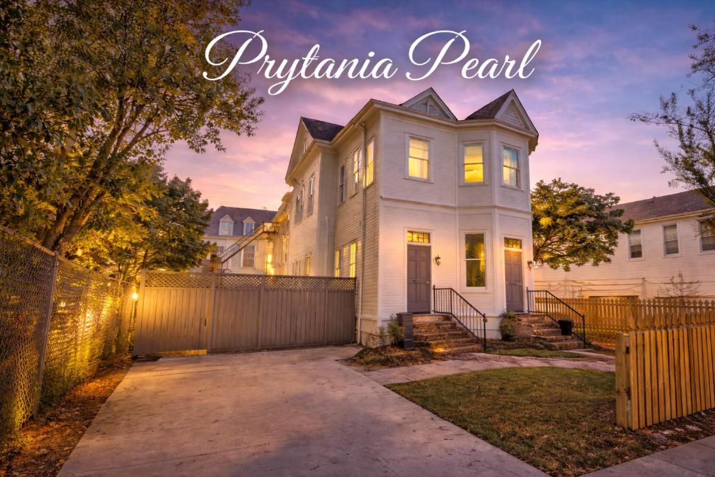 a white house with a fence at Prytania Pearl - 3 Bedroom 2 Bathroom Home in New Orleans