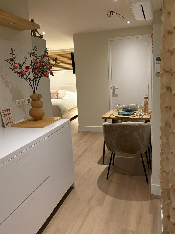 a kitchen and dining room with a table and a chair at Duijnparadijs appartement 2 in Schoorl