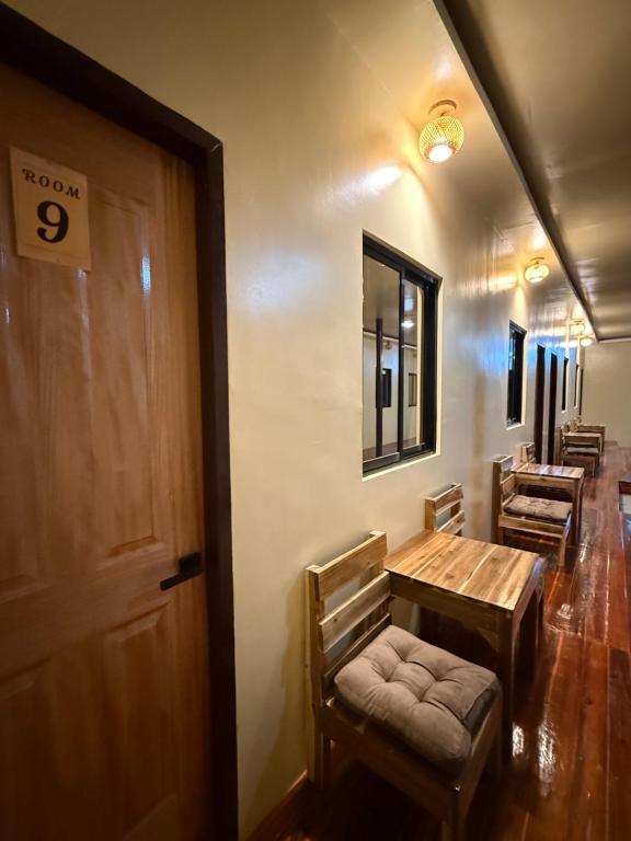 a room with a table and chairs and a door at 9 Keys Inn in San Vicente