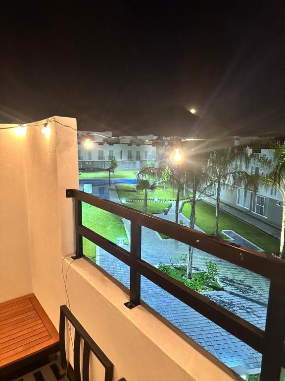 a balcony with a view of a street at night at La Casa de Coco in Tlayacapan