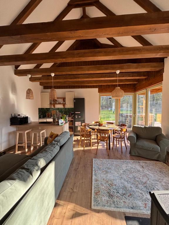 a living room with a long couch and a table at Erdő mellett lebzselő in Mogyoróska