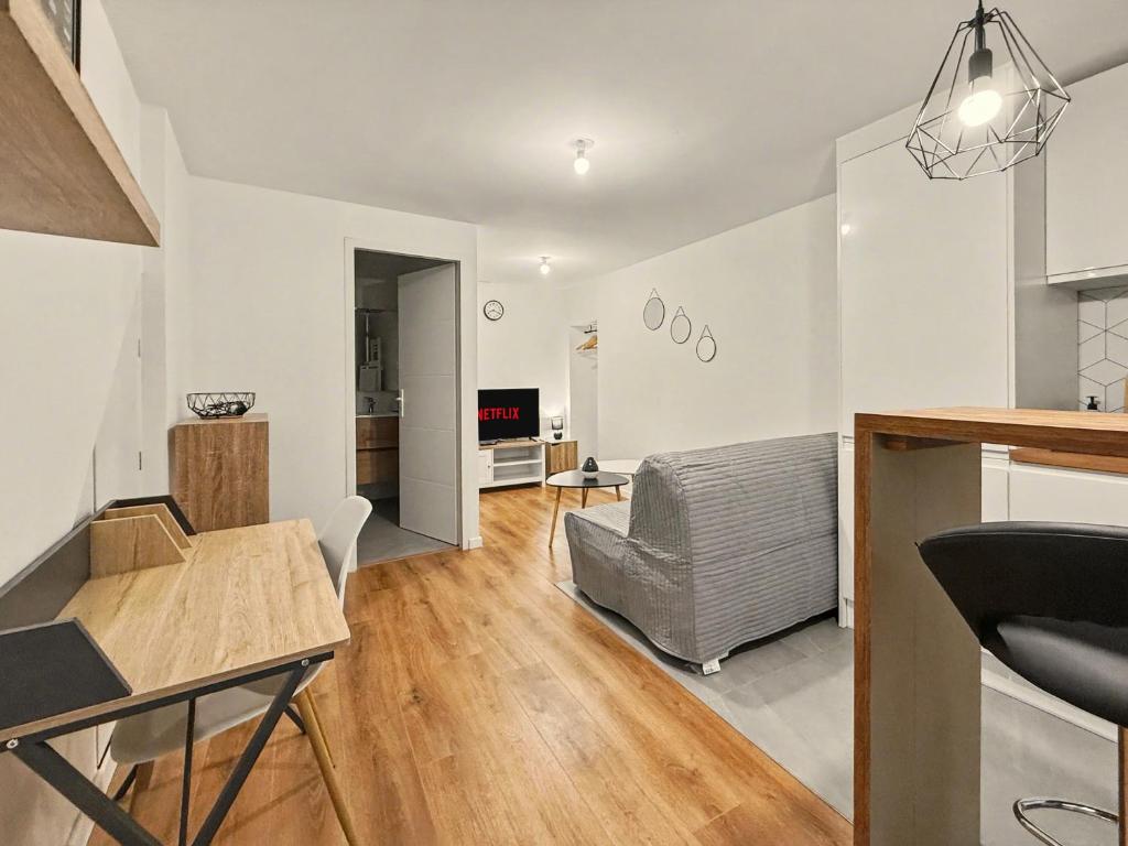 a living room with a couch and a table at Le Refuge in Valence