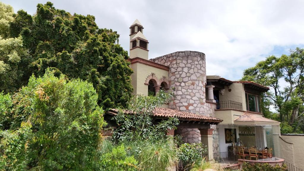 an old house with a tower on top of it at Maja Hotel Boutique in Morelia