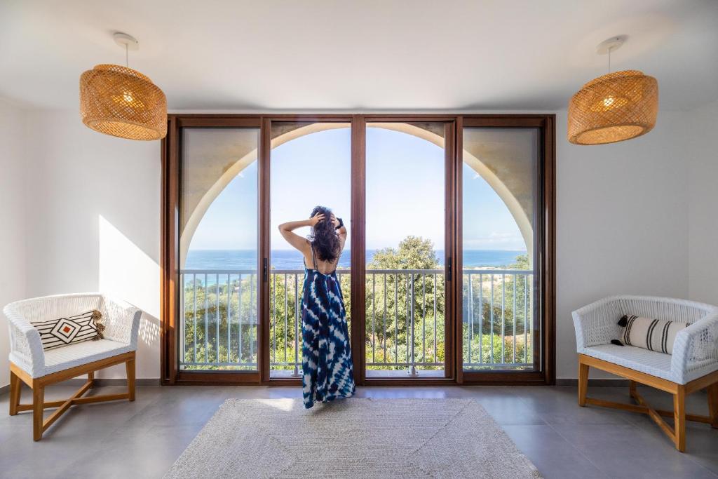 a woman standing in front of a large window at La Listrella Residence & Spa in Monticello