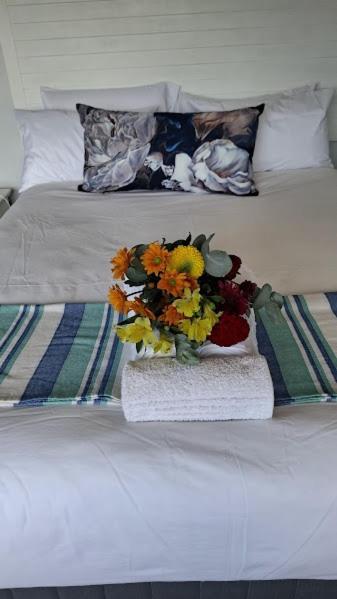 a vase of flowers sitting on top of a bed at AVillaT15SelborneGolfEstatePennington in Pennington