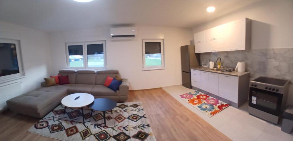 a living room with a couch and a table at Apartment King in Travnik
