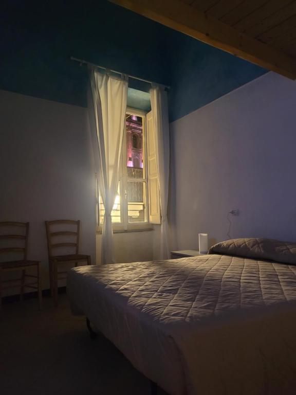 a bedroom with a bed and a window at Appartamento vacanze Loano in Loano