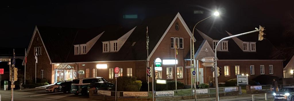 a street light in front of a building at night at Hotel LEANO in Lübeck