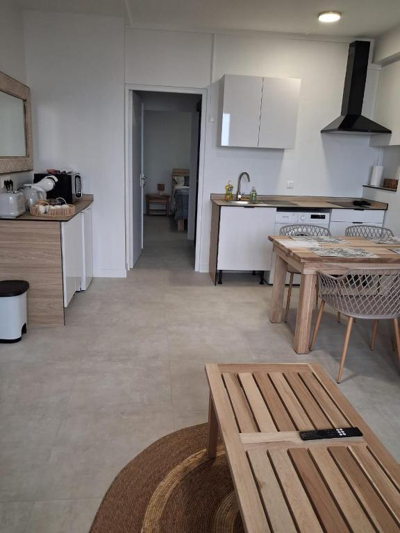 a kitchen with a table and a counter top at L'écrin de Saint-pierre - Sunset & Sea View in Saint-Pierre