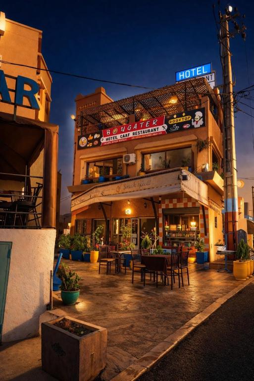 a restaurant with tables and chairs in front of a building at Hôtel Restaurant BOUGAFER in Boumalne Dades