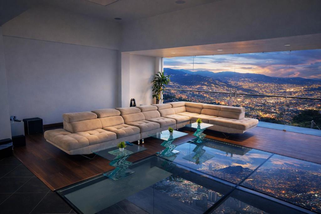 a living room with a couch and a glass table at Glass Mansion Breathtaking 180 Panoramic View in Envigado