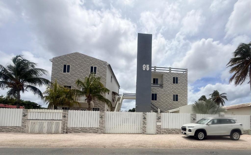 a white car parked in front of a building at Downtown apartments in Kralendijk