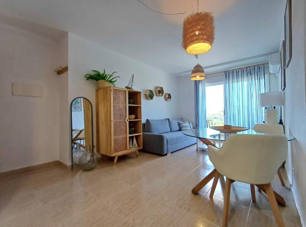 a living room with a couch and a table at Charli beach in Miramar