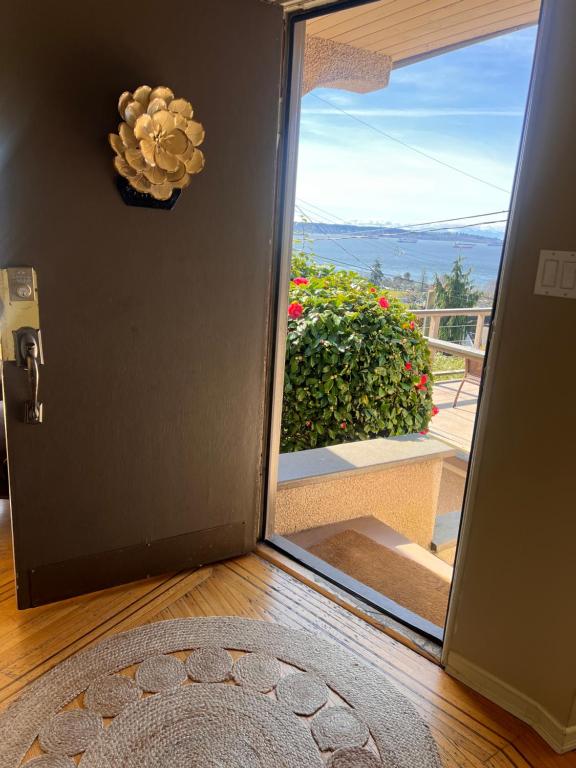 a door with a view of a balcony at Sunset Ocean Retreat in West Vancouver
