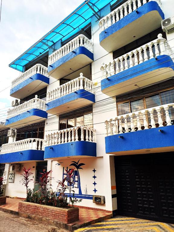 a building with blue and white balconies on it at Hotel Los Balcones de Apulo in Apulo