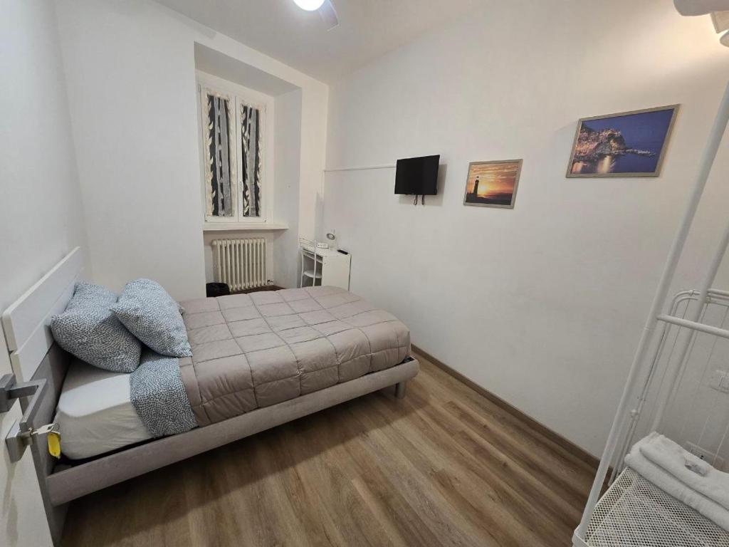 a bedroom with a bed in a white room at Danito Rooms 3 singola in Ancona