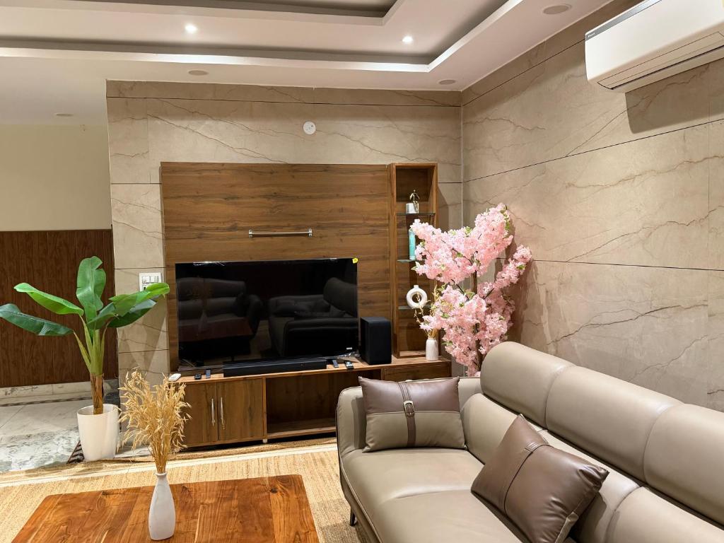 a living room with a couch and a fireplace at Kubn Retreat in Chandigarh Airport