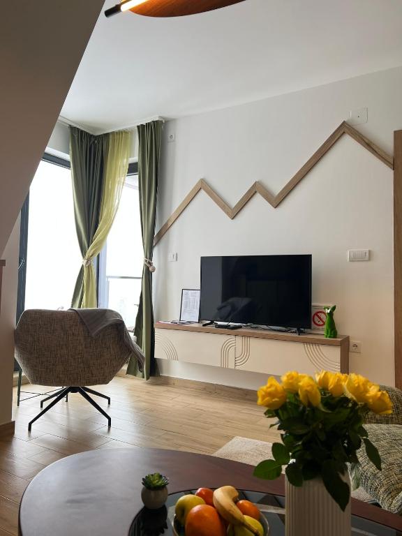 a living room with a television and a table at Valena 2 - Divčibare Free private Parking in Divčibare