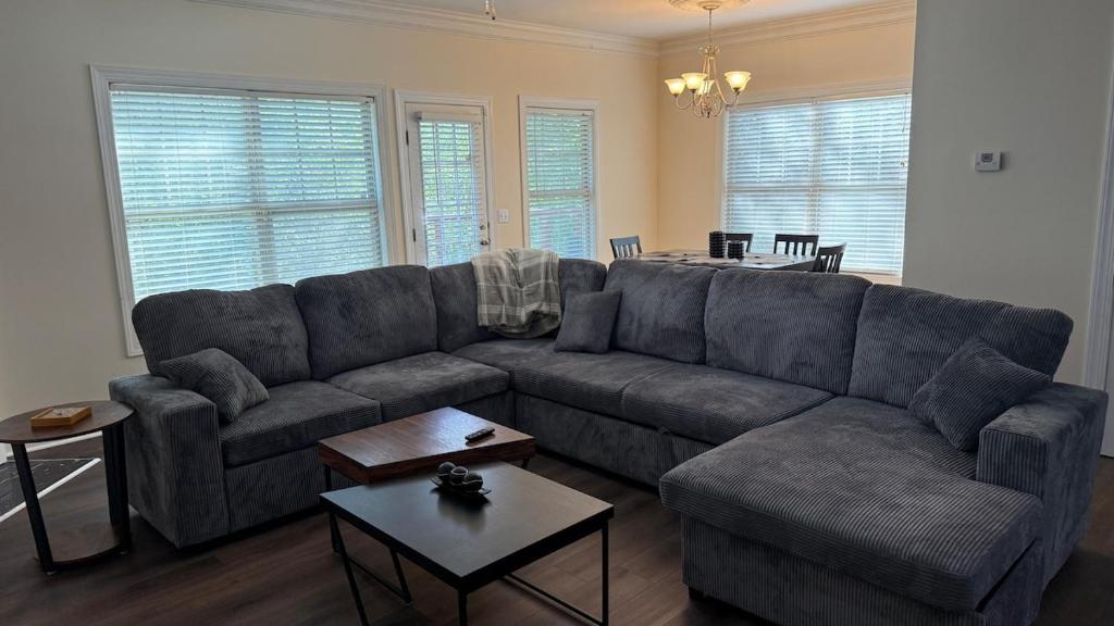 a living room with a couch and a table at Charming townhouse ideally situated in Grayson in Grayson