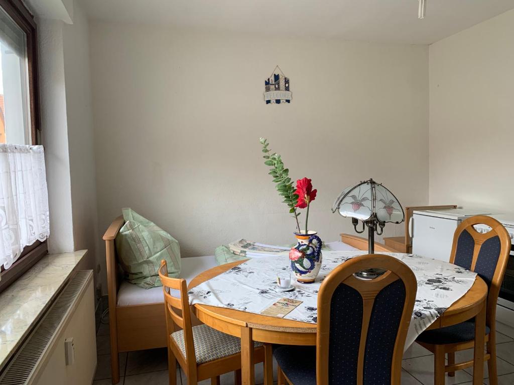 a dining room table with a vase of flowers on it at Brakel Monteure Ferienwohnung 1 in Brakel