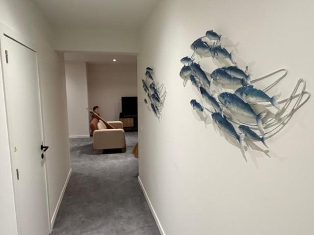a hallway with a wall with fish on it at Caribean Style in Middelkerke