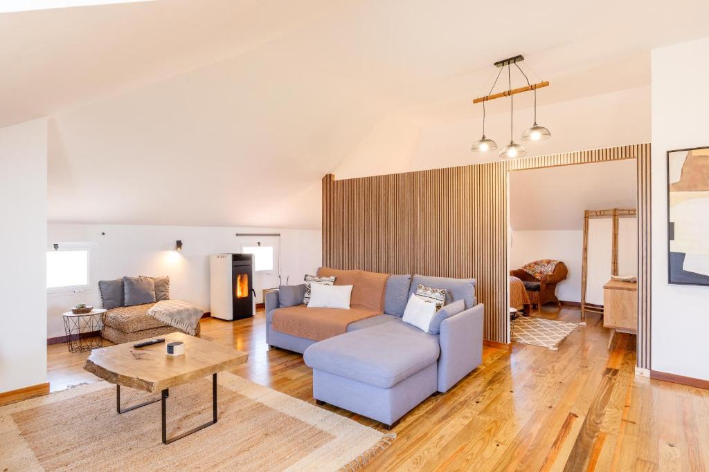 a living room with a couch and a table at Casa das Eiras, Nº48 in Santana
