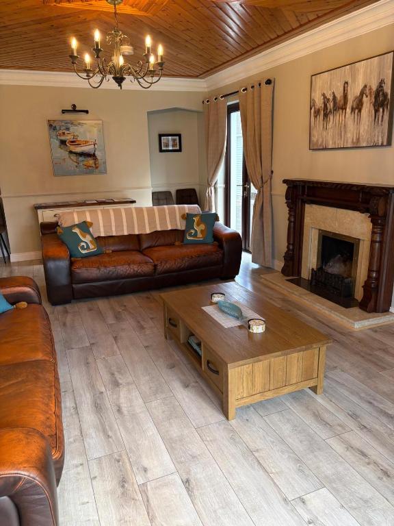 a living room with a couch and a coffee table at Whitepark Lodge in Lisnaskea