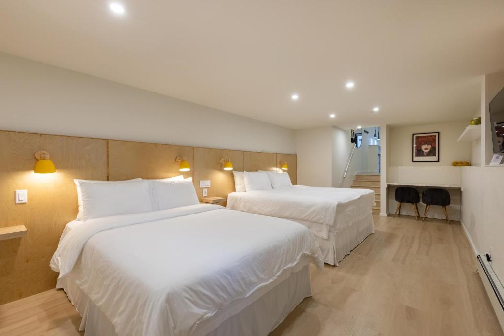 two beds in a hotel room with white sheets at Modern King-Size Guest Suite with AC in Burnaby