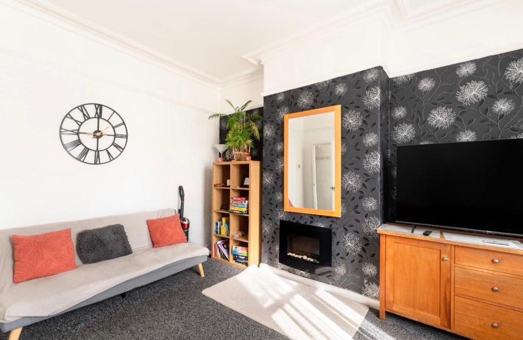 a living room with a flat screen tv and a couch at Rotherham Kimberworth in Kimberworth