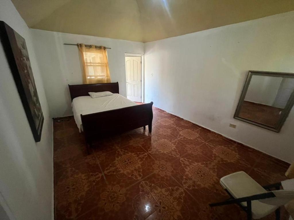a bedroom with a bed and a mirror and a chair at Value guests in Magaeline