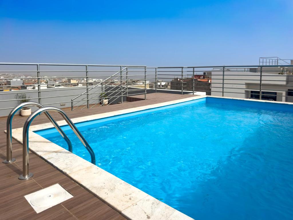 a swimming pool on the roof of a building at Cozy 1-bdr apt, Cidadela, rooftop pool - LCGR in Praia