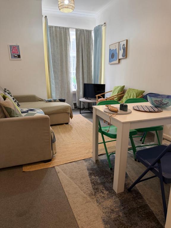 a living room with a couch and a table at Cobble retreat high street in Hastings