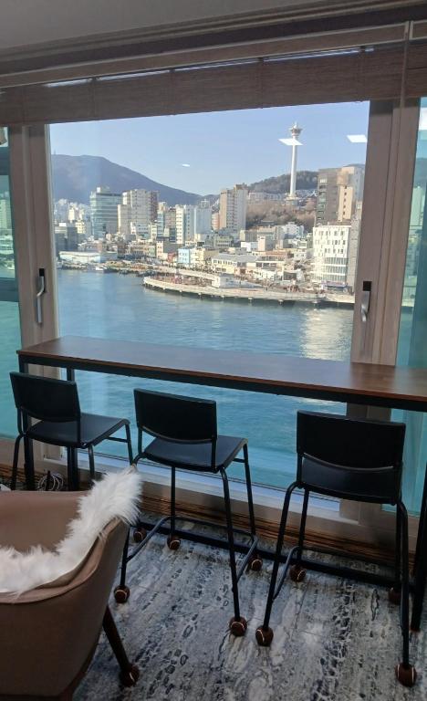 a room with chairs and a view of the water at 부산남포 프론트오션뷰 in Busan