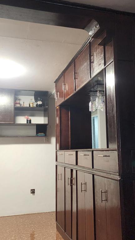 a kitchen with a large wooden cabinet in a room at Casa Minsorado in General Trias