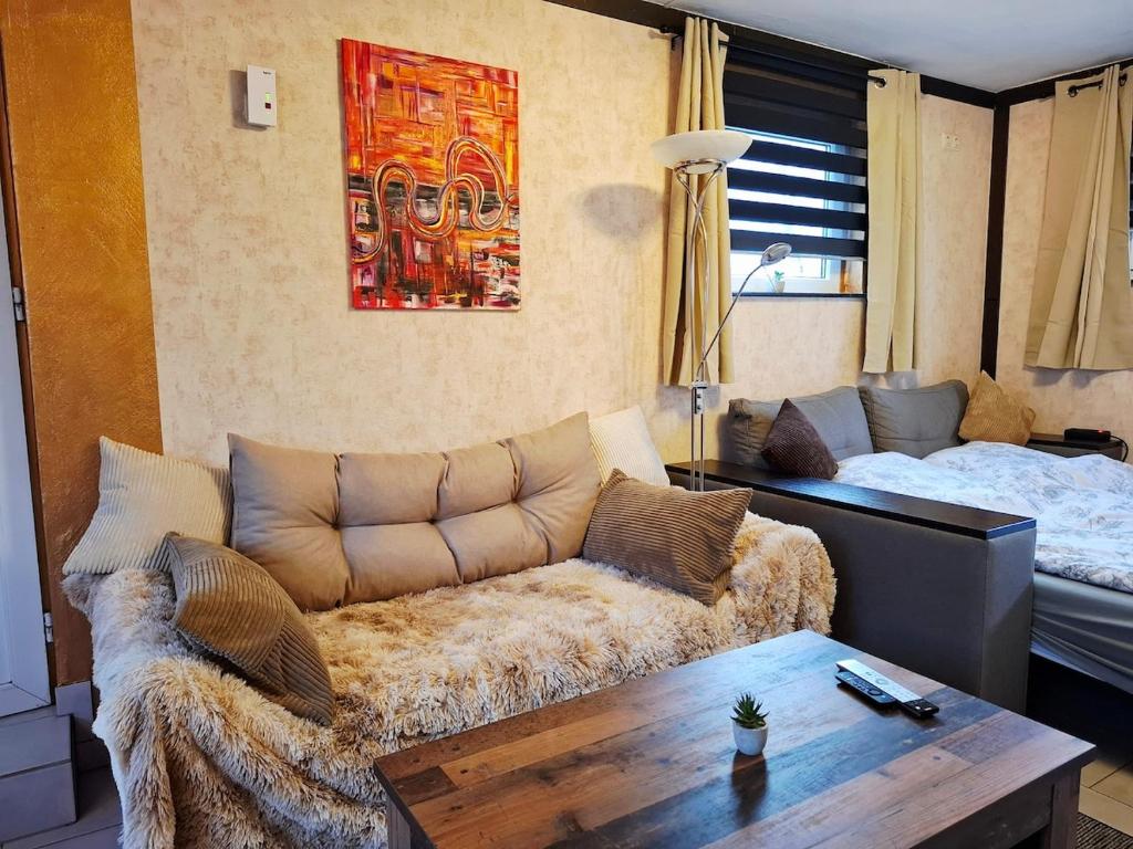 a living room with a couch and a bed at Ruhe Oase mit Gartenblick in Büren