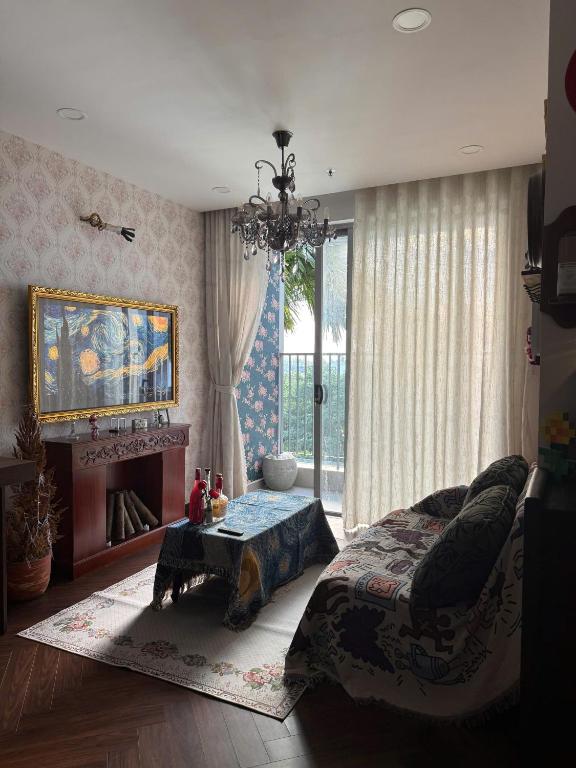 a bedroom with a bed and a fireplace and a chandelier at 221B Baker in Ga Phú Văn