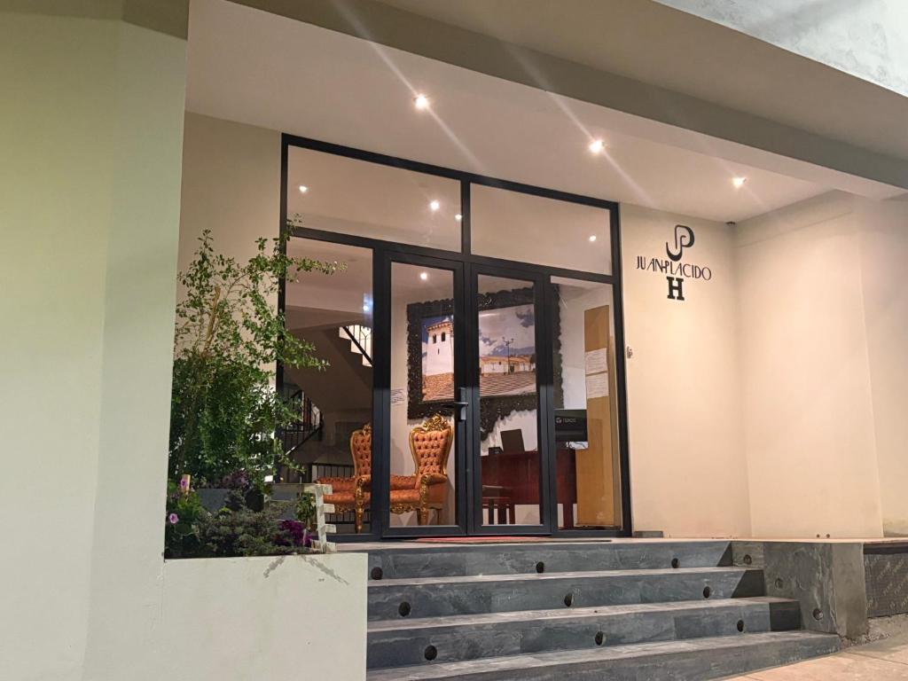 a store front with stairs in front of it at Juan Placido Hospedaje in Cusco