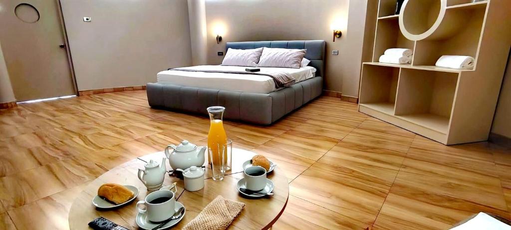 a room with a bed and a table with food on it at Altitud 620 Boutique Suites in Nazca