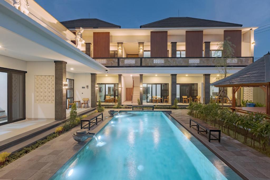 a house with a swimming pool in front of it at DC 08 Residence in Dalung