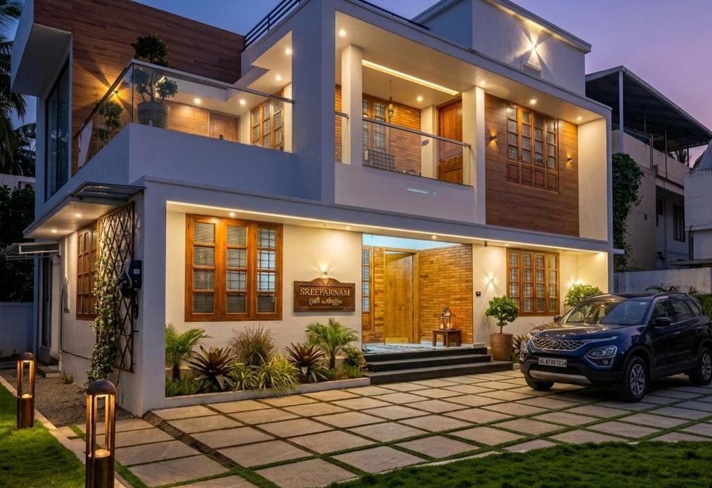 a house with a car parked in front of it at Tranquil Home in Trivandrum
