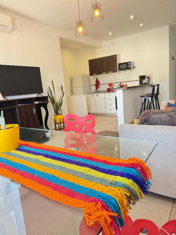 a colorful rug on a glass table in a living room at BELLA VISTA - CAFAYATE in Cafayate