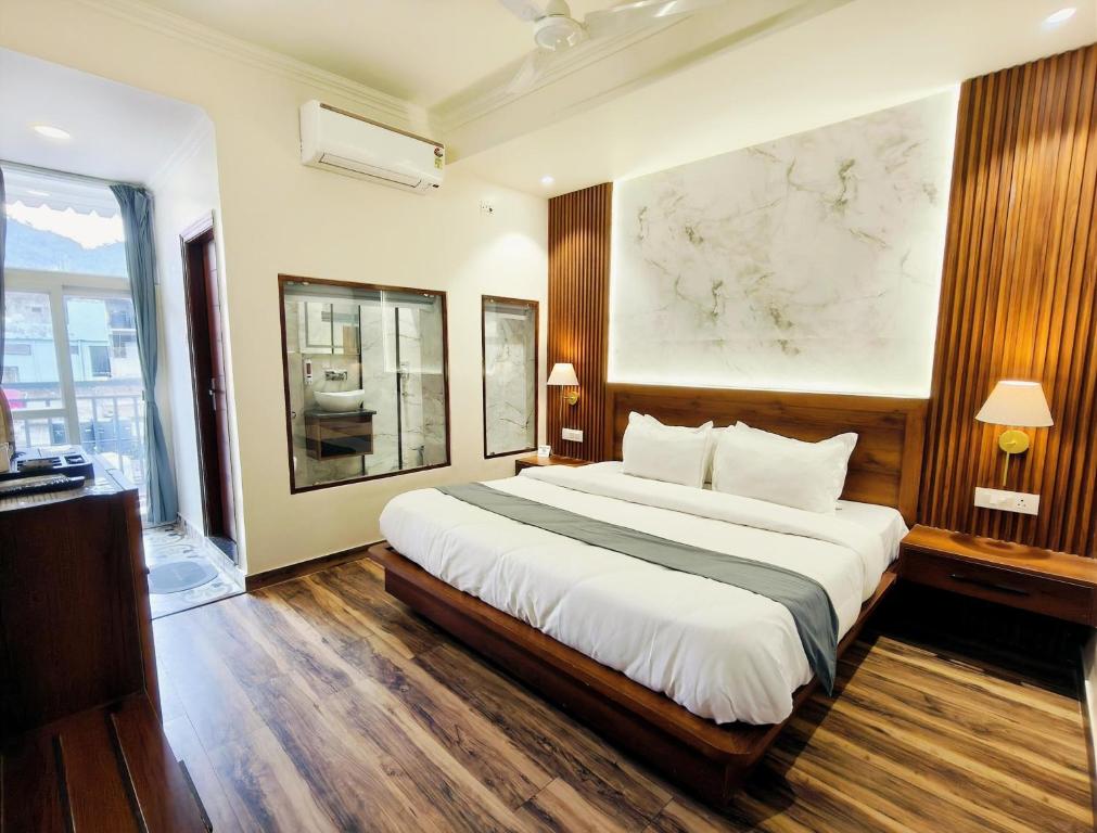 a bedroom with a large bed and a large window at Paradise Boutique Stays in Solan