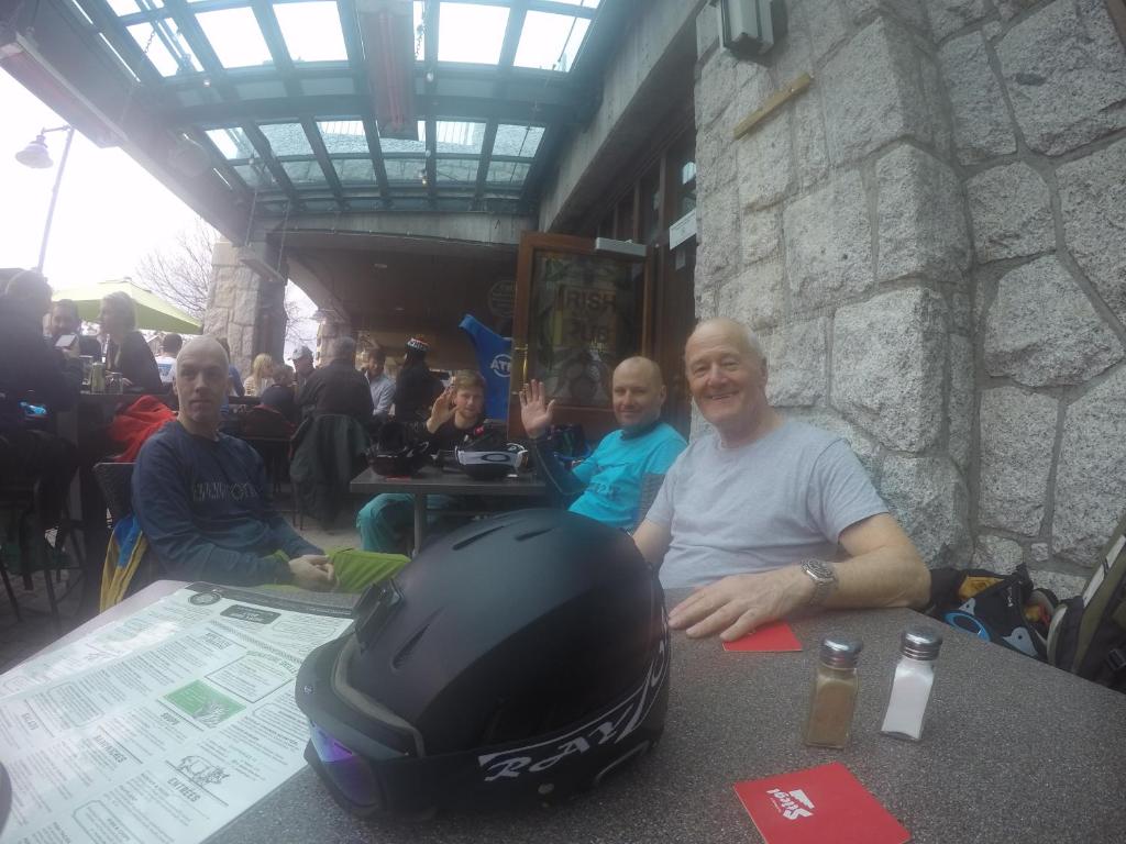 a man sitting at a table with a helmet on it at RUBY LODGINg in Banilad