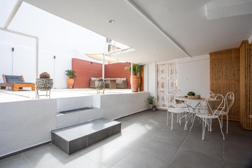 a kitchen and living room with a table and chairs at Iriada House in Rhodes Town