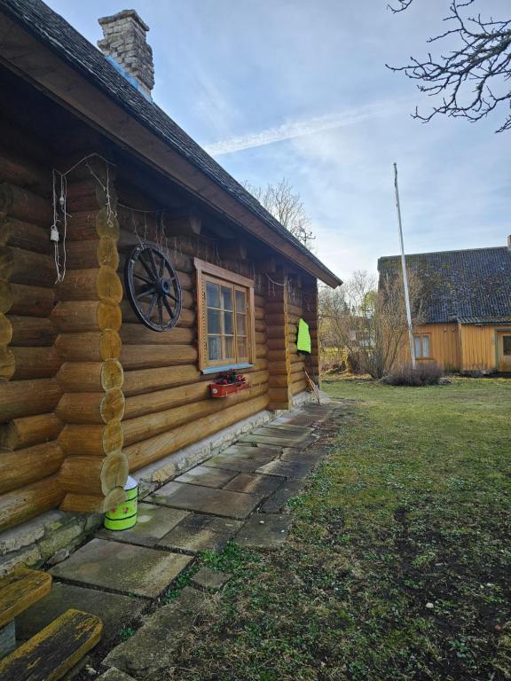 a log cabin with a window on the side of it at Pitsinina Log House in Kaugatuma