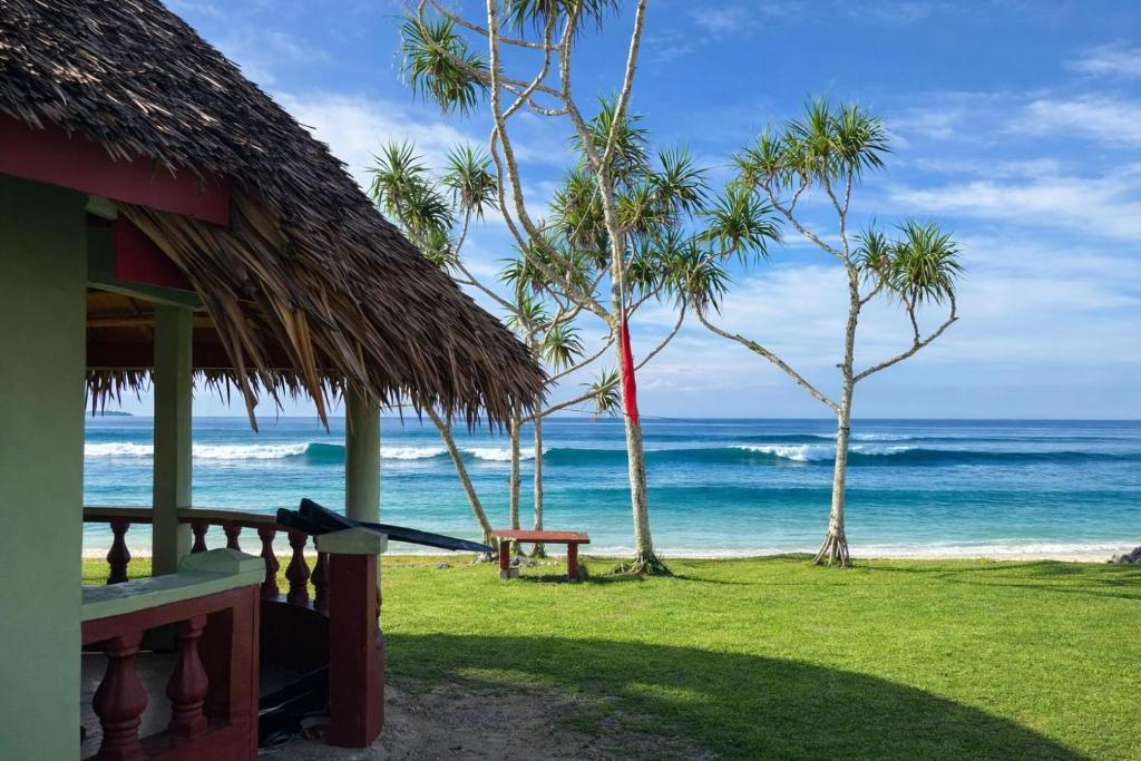 a view of the ocean from a beach with a hut at Leimalo's Bungalow in Port Vila